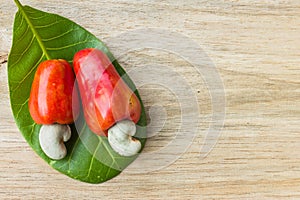 Cashew nut and leaf on wood