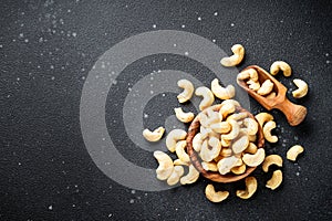 Cashew nuts in bowl at black background.