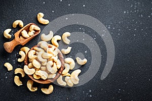 Cashew nuts in bowl at black background.