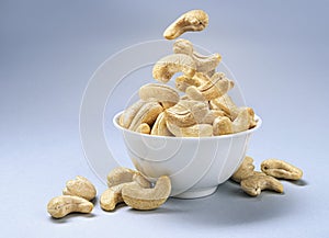 Cashew nuts into bowl with copy space