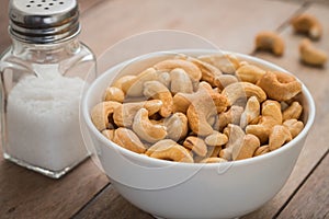 Cashew nuts in bowl and salt shaker