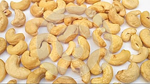 Cashew nuts close up rotating full frame background, looped spinning cashew