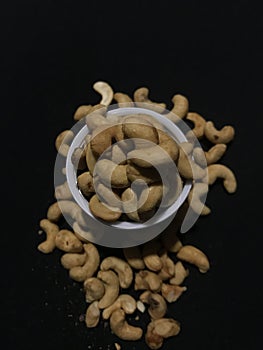 Cashew Nuts, deep fried and  in the black background.