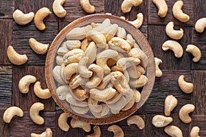 Cashew nuts peeled roasted in wooden bowl, top view