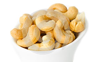 Cashew nuts in a white bowl.