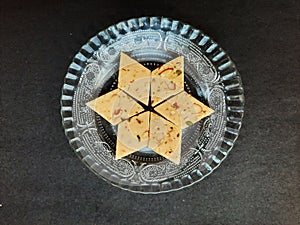 cashew sweet in plate isolated on black background