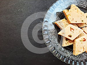 cashew sweet in plate isolated on black background