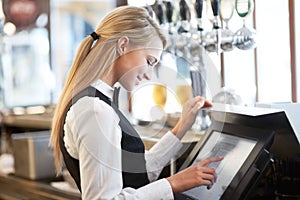 Cashier, barista and young woman waitress in cafe checking for payment receipt. Hospitality, server and female butler