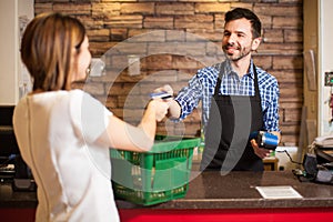 Cashier receiving a credit card payment