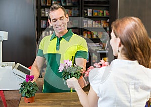 Cashier in retail store serving client