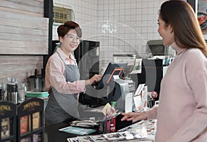 Cashier staff receive customer orders from a waitress