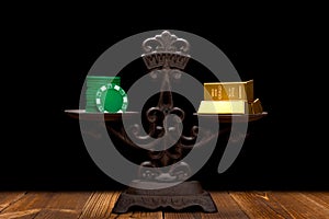 Cashino chips & gold bars on a balanced scale