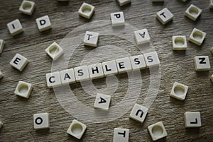 Cashless word made of square letter word on wooden background