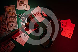 Casino, blackjack and poker theme with cards, handcuffs, wooden gavel and chips, top view