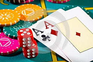 Casino chips with dice and playing cards on game table. Concept of gambling or poker and entertainment. Two aces on the