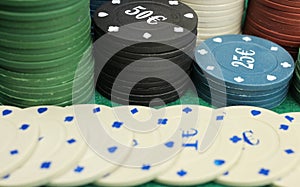Casino chips on green field background, gambling, selective focus