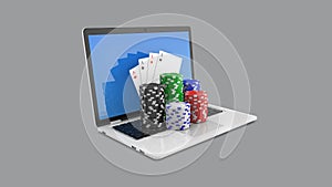 Casino chips and playing cards on laptop, online casino concept. Gambling chips poker cards money on laptop computer.