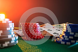 Casino chips on a poker table against the background of cards, money with creative light