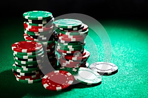 Casino chips stack on green table. Gambling concept.