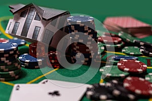 Casino chips with toy house - housing market gamble concept