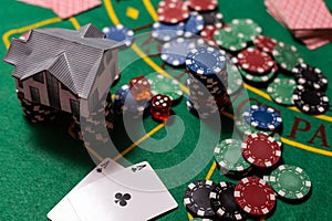 Casino chips with toy house - housing market gamble concept