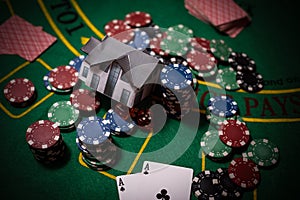 Casino chips with toy house - housing market gamble concept