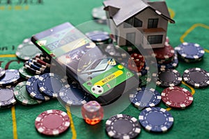 Casino chips with toy house - housing market gamble concept.