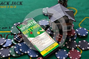 Casino chips with toy house - housing market gamble concept.