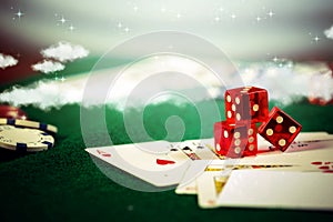 Casino dice with poker chips in gamble green table.