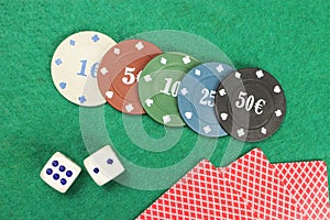 Casino elements-dice, chips, cards-a combination of Royal flush on a green felt table