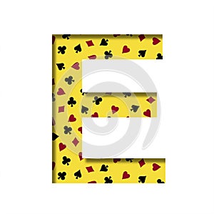 Casino font. The letter E cut out of paper on the yellow background of the pattern of card suits spades hearts diamonds and clubs