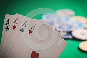 Casino, gambling concept. Four aces and blur poker chips on green felt