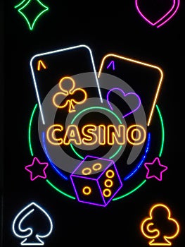 Casino neon sign with glowing dice and cards