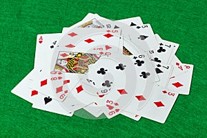 Casino playing cards on green table