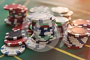 Casino poker chips on green felt background. All for success game