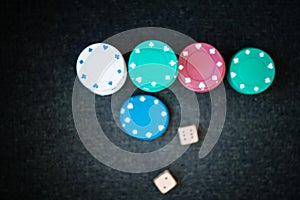 Casino poker chips stack dice on green felt background