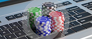 Casino poker chips stacks on a laptop keyboard. 3d illustration