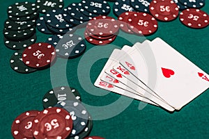 Casino poker gambling and winning combination. Royal flush and a bet of chips on table background