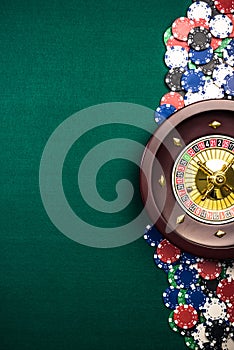 Casino Roulette Background with Roulette Drum,Casino Chips on Green Felt Table