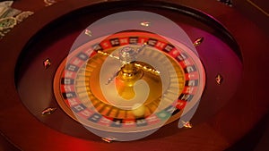 Casino roulette in motion with spinning wheel and ball. Winning number 15 and color Black is determined by the roulette