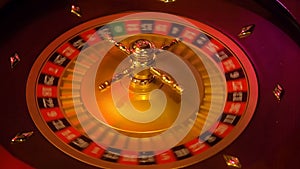 Casino roulette in motion with spinning wheel and ball. Winning number 23 and color Red is determined by the roulette