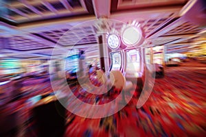 Casino theme out of focus , motion blurred rows of Casino slot machines in a casino with Shallow Depth of Field. Las Vegas