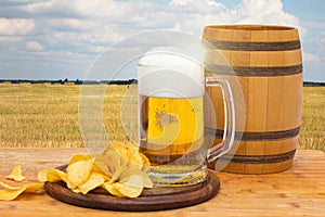 Cask beer and chips on the background.