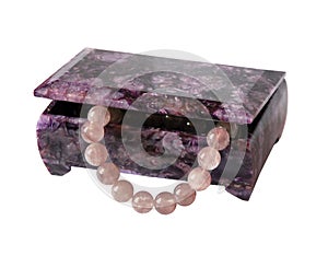 Casket from charoit with a beads from quartz photo