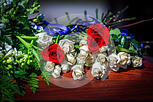 Flowers On A Casket With Red And White Roses