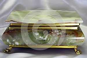 Casket from onyx in a gold frame