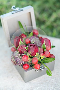 Casket for wedding rings with fresh flowers for ceremony