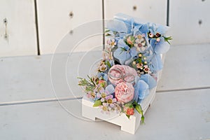 Casket with wedding rings and fresh flowers in pink-blue colors for ceremony