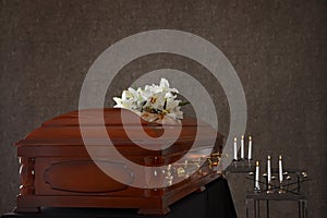 Casket with white lilies in funeral home