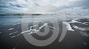 Caspian sea under blue sky in early September, snag on the beach